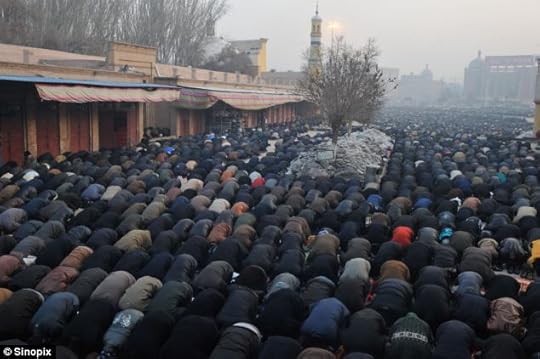 Thousands of Uighur Muslims pray outside the Id Kah Mosque