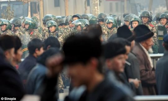 Riot police watch Muslims gathering in Kashgar