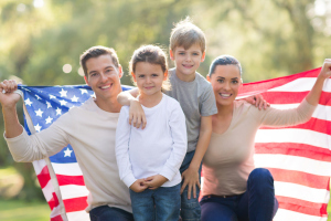 Family-of-four-holding-an-American-flag
