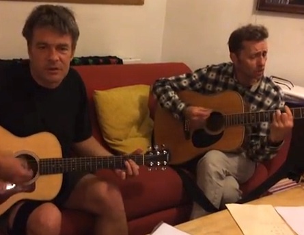 A screenshot of a video featuring Andy Worthington and Richard Clare, two of The Four Fathers, playing an acoustic version of 'Song for Shaker Aamer.'