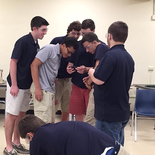 Students gather around to take stock of their hand-held videos of each launch to enthusiastically record just where the projectiles landed. Competition is fun!