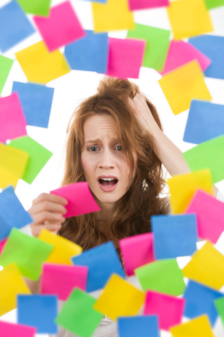 Stressed woman with pink note surrounded by colorful post-it reminders