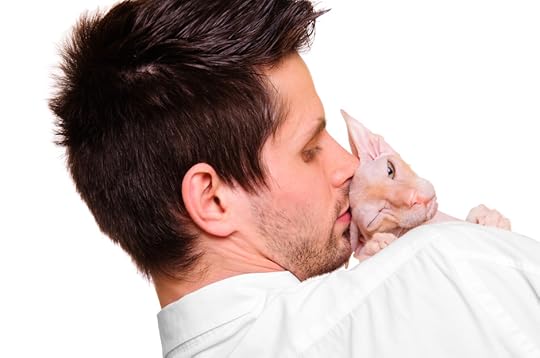 man in white shirt holding a cat breed Don Sphynx on his hands. isolated on white. close-up