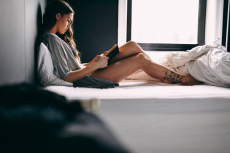Pretty Young Lady Reading A Book On Bed