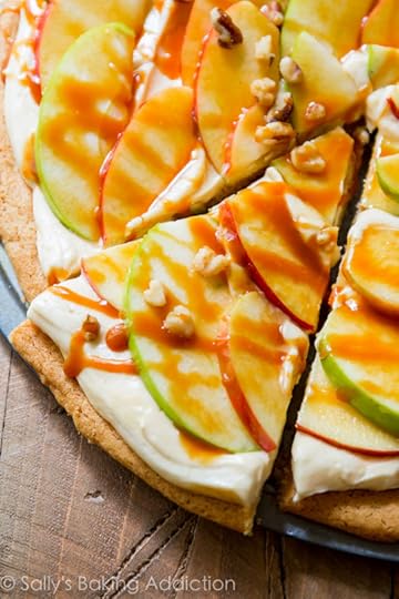 This apple dessert pizza with caramel cream cheese frosting is a show stopped! It's simple to make and it's all prepared on a snickerdoodle cookie crust!
