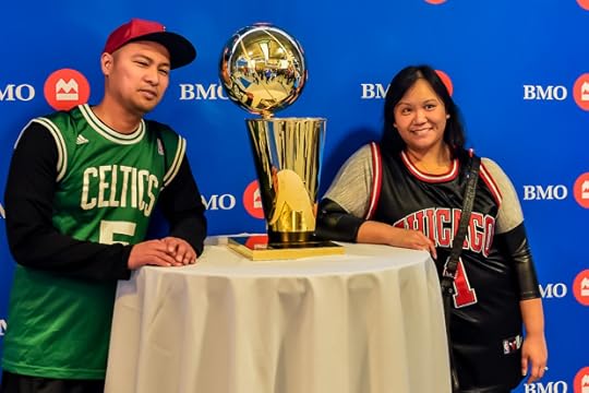 Fans get their pictures taken with the Larry O'Brian Trophy. (Photo by Jeff Miller)