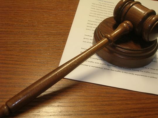 Photograph of a judge's gavel on a desk with some paperwork