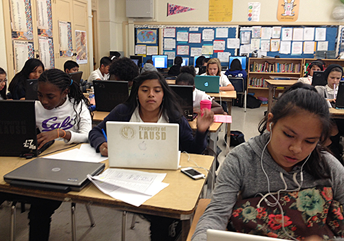Students writing their novels on laptops.