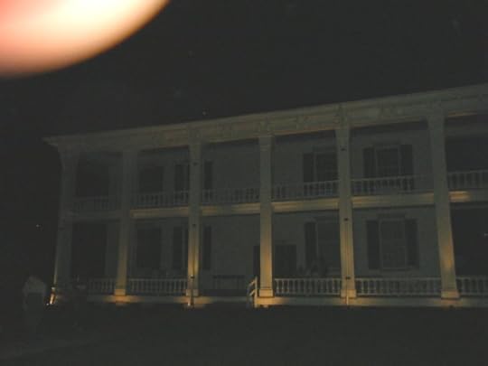 What seem to be a family of ghosts assembled on the back porch. The McGavock family?