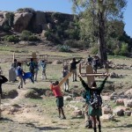 Children carrying desks to various outdoor classes