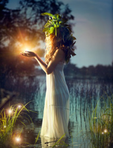 Fantasy girl taking magic light. Mysterious night scene