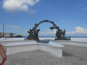 ornate fountain against an ocean backdrop