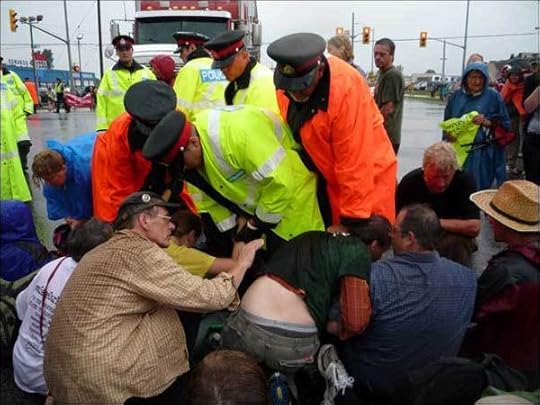 Protesters trying to block the removal of dairy cattle from the Frontenac Institution farm in Kingston, Ontario, in August 2010 are arrested by police (photo courtesy Alec Ross)