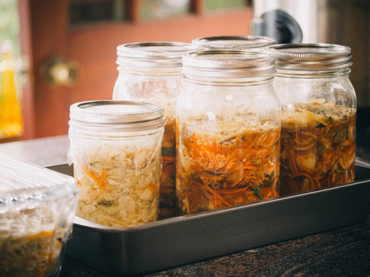 Sauerkraut and kimchi fermenting in the kitchen