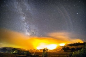 Aug. 12, 2015 - Clearlake, California, U.S. - A meteor from the Perseid Meteor shower can be seen in the upper left corner in this long exposure image as the Jerusalem Fire burns in Lake and Napa Counties near the town of Clearlake. The Jerusalem Fire burns off Morgan Valley Rd after jumping north of the highway. The fire has burned 14,000 acres and is only 5% contained. Mandatory evacuations were in place. (Credit Image: © Stuart Palley via ZUMA Wire)