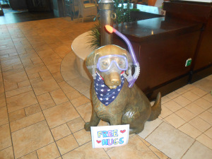 Dog statue dressed up in face mask and snorkel.