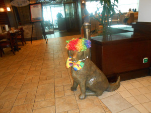Dog sculpture with bright wig
