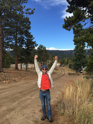 Benjamin Rubenstein with mountain skyline in Nederland, Colorado, on vacation visiting breweries