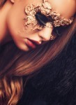 Woman with creative carnival mask on her face