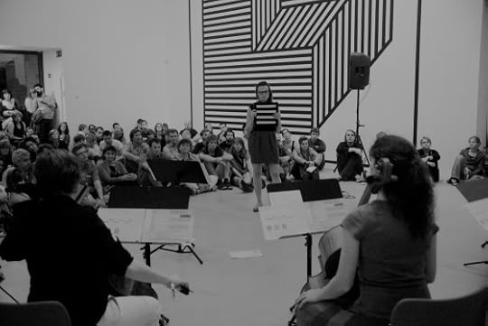 Vantzou (standing) in a performance at M-Museum in Belgium with a six-piece cello ensemble