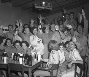 Servicemen and servicewomen raise a toast to victory on VJ Day in 1945. Veterans History Project. 