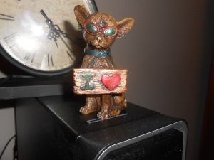 Tourist sculpture of a dog with sunglasses and says I heart.