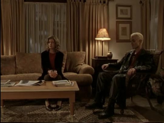Joyce sitting on the couch very primly, Spike sitting in a chair, neither of them speaking or looking at each other.