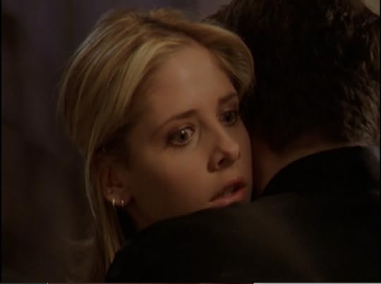 Buffy, looking over Angel's shoulder as the vortex opens.