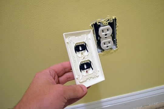 The back of the Shock Shutter showing the black shutters. It's designed in such a way that it only allows access when an actual electrical plug is inserted evenly into the outlet. Other objects will not get past these built-in shutters.