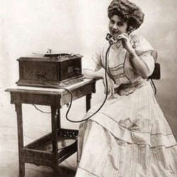 woman speaking on an old fashioned telephone BW