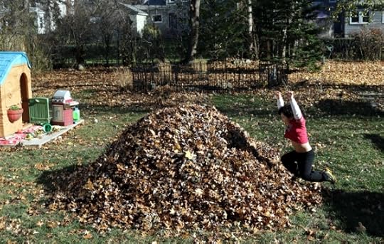 The Pip mid-leap into the leaf pile in the back yard of Chateau Steelypips.