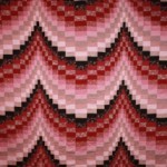 Bargello – the pieces range from the smallest, ½ square inch, to the largest ¾” inch by 2” inches. This quilt is entirely hand sewn and hand quilted. It was made for a king sized bed. This is a close-up picture to show the detail.