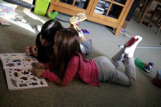 SteelyKid and The Pip discussing the finer points of Lego superhero stickers.