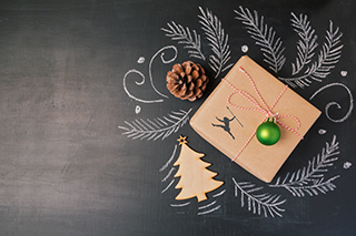 Christmas holiday gift on chalkboard background. View from above