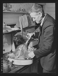 Mr. T.L. Crouch, a Rogerine Quaker, preparing to carve the Thanksgiving turkey. Photo by Jack Delano, Nov. 1940. Prints and Photographs Division. 