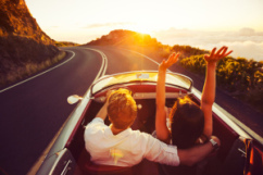 Happy Couple Driving on Country Road into the Sunset in Classic