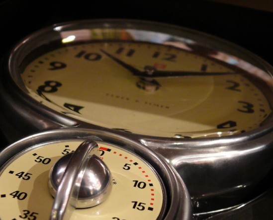An image of an old timer with a clock at the top and a timer at the bottom