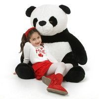 giant stuffed panda with little girl: 