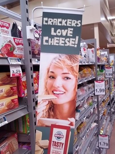 A supermarket advertisement depicting a very blonde white lady eating cheese and crackers, with the unfortunate slogan,