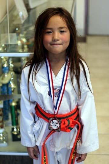 SteelyKid with her silver medal from today's taekwondo tournament.