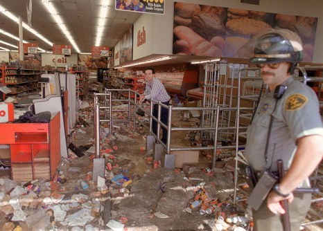 (FILES) In this dated April 30, 1992 filed photo shows a store owner and a Los Angeles Police Department (LAPD) officer look at the damage caused by looters in Los Angeles. Los Angeles marks the 20th anniversary of the city's riots aPRIL 29, 2012, climaxing weeks of public hand-wringing about the deadly 1992 unrest sparked by the on-camera police beating of a black motorist. A series of events is scheduled, including speeches by civil rights activist the Reverend Al Sharpton and LA Mayor Antonio Villaraigosa, and a community 