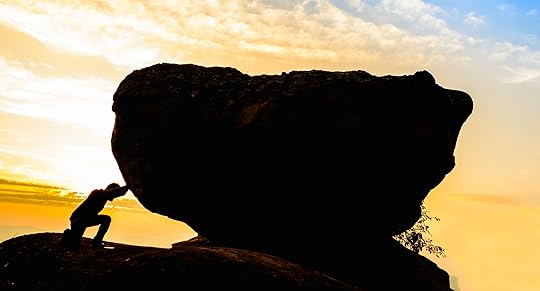 Hard work.The person rolls the rock on mountain.