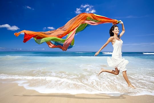 Happy woman jumping on beach