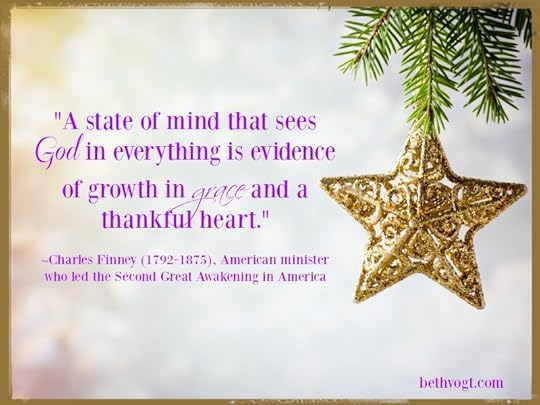 Spruce branch with Christmas decorations on a gray background.