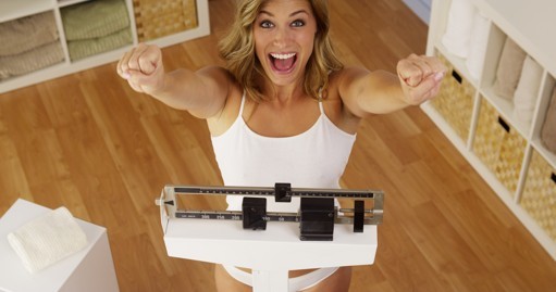 Happy woman on scales