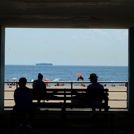 Looking onto the beach and the silhouettes of three men