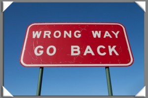 Wrong Way Go Back sign with corners