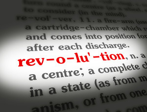 Dictionary definition of the word REVOLUTION on paper.