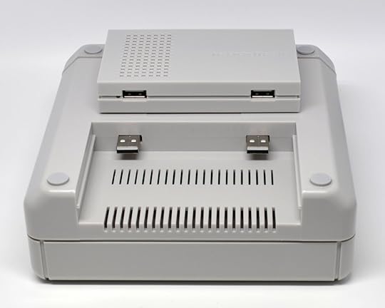 The main part of the console sitting on top of the bottom of the cartridge unit.