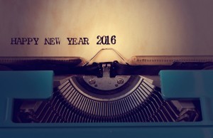 closeup of a yellowish paper with the text happy new year 2016 in an old blue typewriter